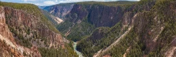A canyon in Yellowstone National Park with a river running through it.
