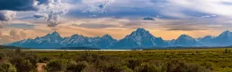 A mountain range with clouds in the sky.