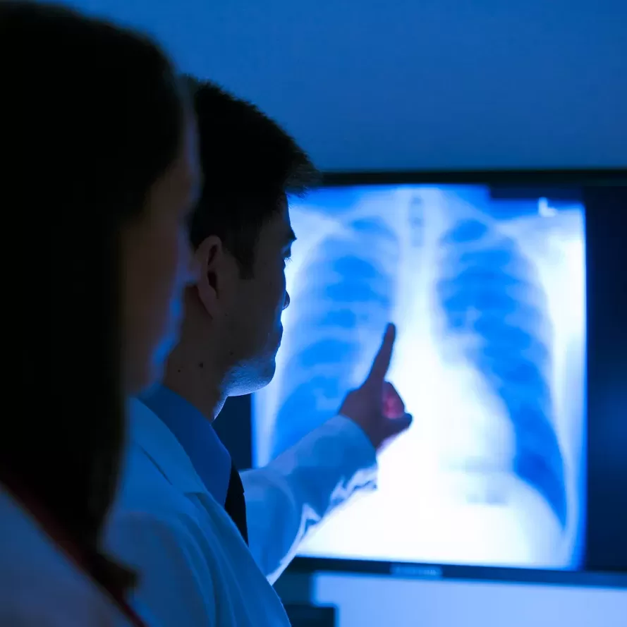 A group of medical professionals examining an x-ray.