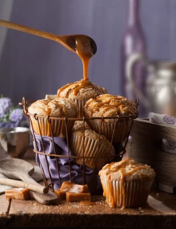 A basket of muffins with caramel drizzled on them, captured in exquisite detail for a food photography portfolio.