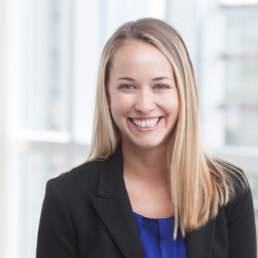 A smiling business woman in a headshot.