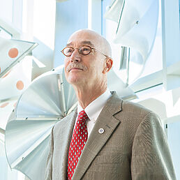 Portrait of a man in a suit and tie.