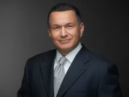 A man in a suit and tie posing for headshots.