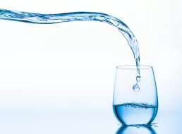 Water being poured into a glass for healthcare photography.