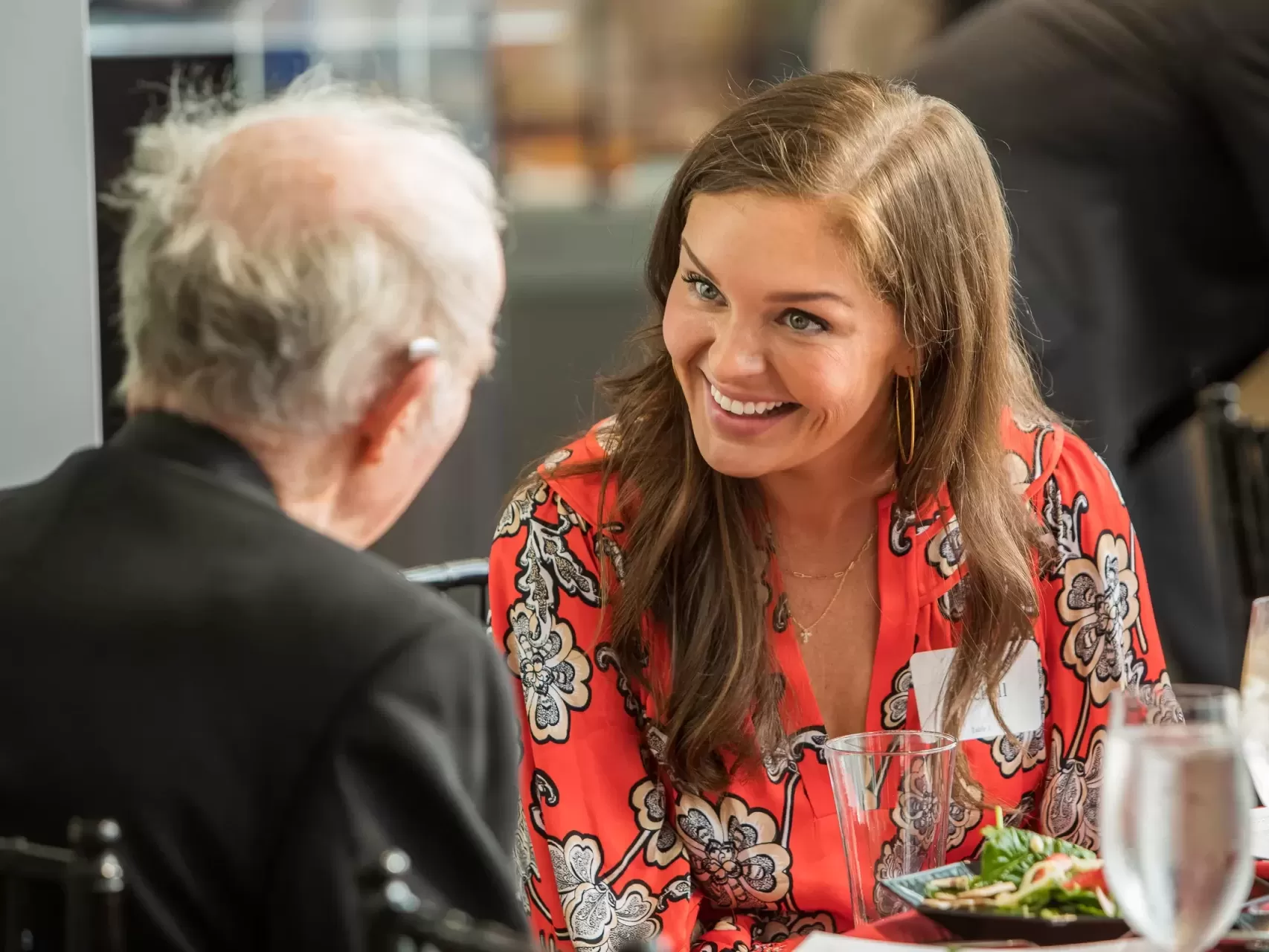 A woman and an older man sitting at a table for healthcare event photography.