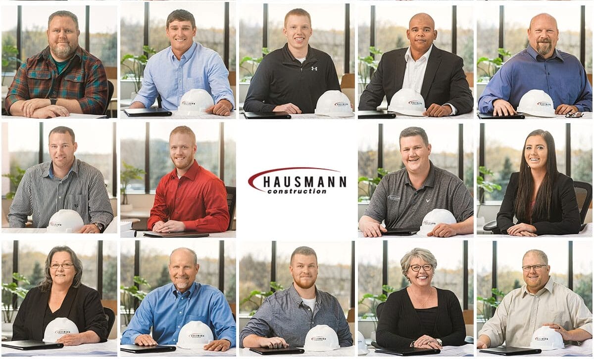 Hausmann Construction team members with hard hats in a professional office portrait grid.
